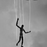 hand holding marionette strings